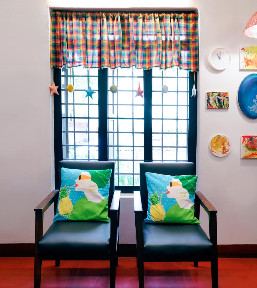 A room with a couple of chairs sitting in front of a black framed window - Beautiful Homes
