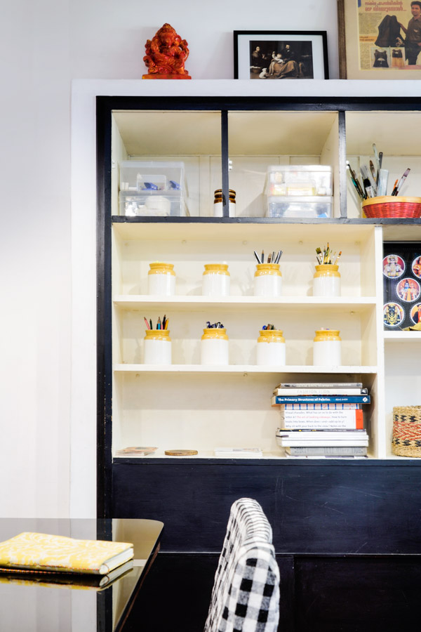 A black framed storage area with pickle jars used as pencil stands - Beautiful Homes