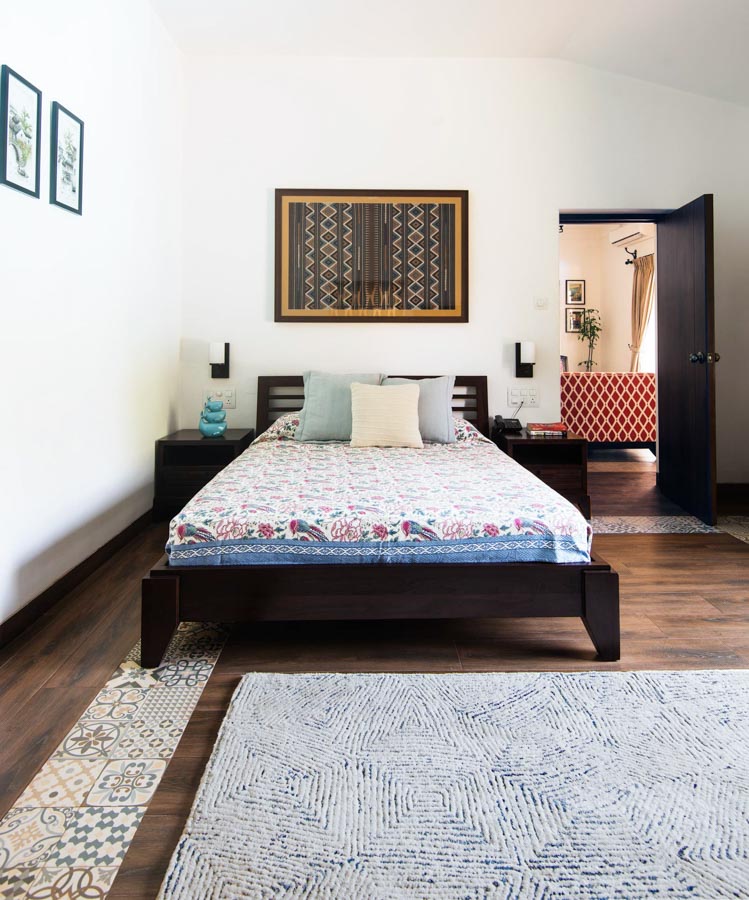 Uncluttered Indian bedroom design & décor with wooden floor interrupted by ethnic-print tiles - Beautiful Homes