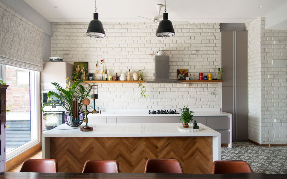 Open kitchen with island and white brick walls
