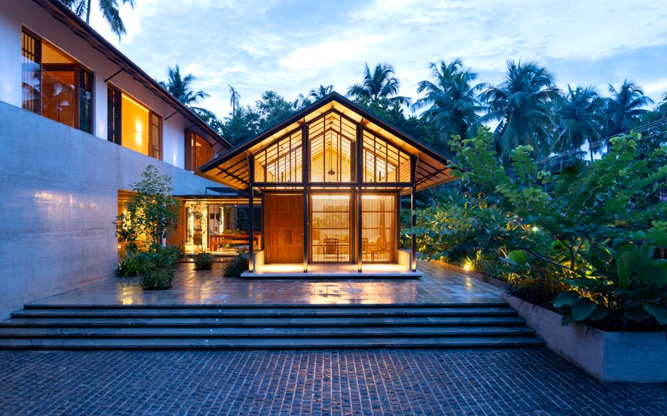 A bungalow in kerala with an extension building
