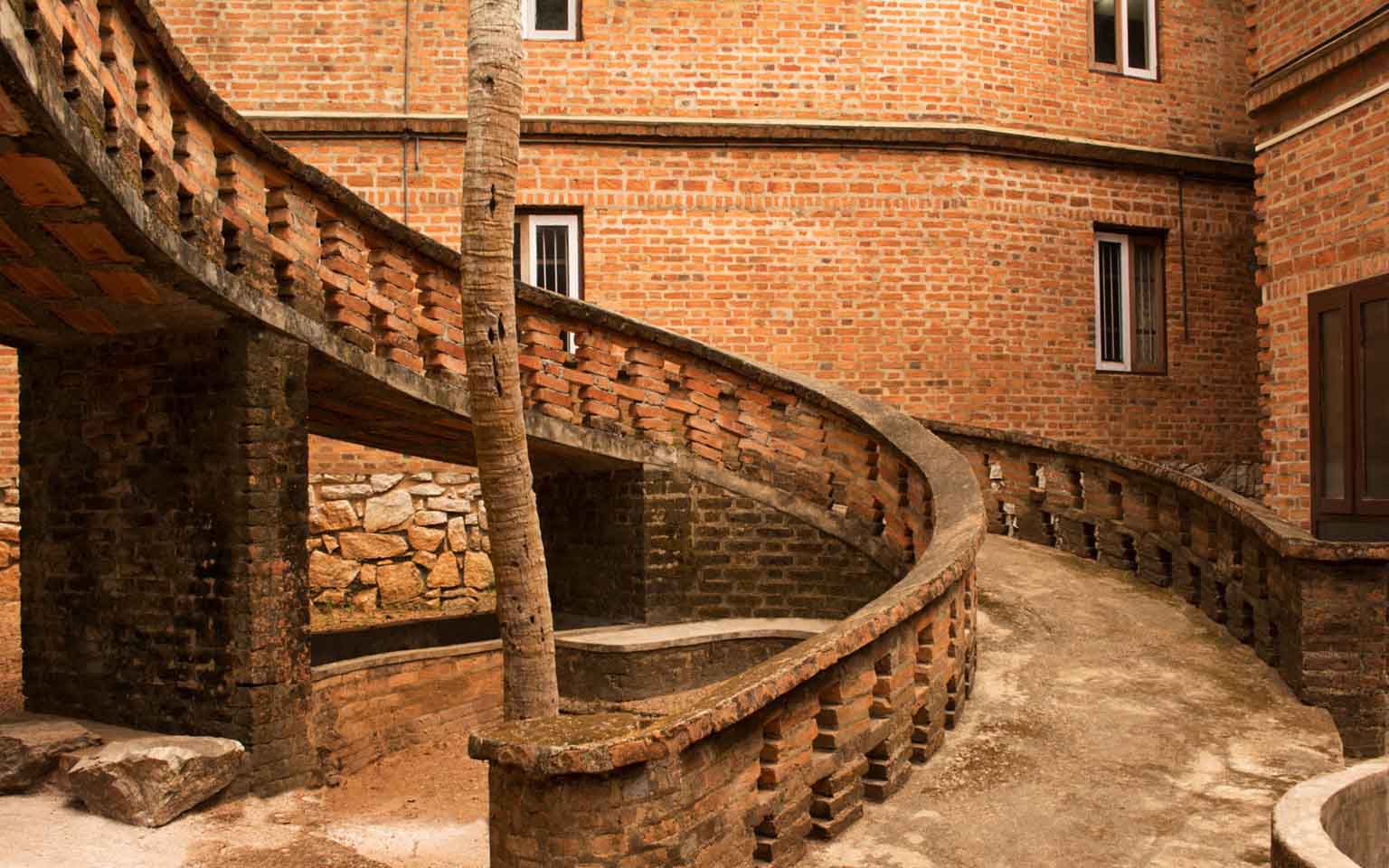 A spiral pathway built using red bricks