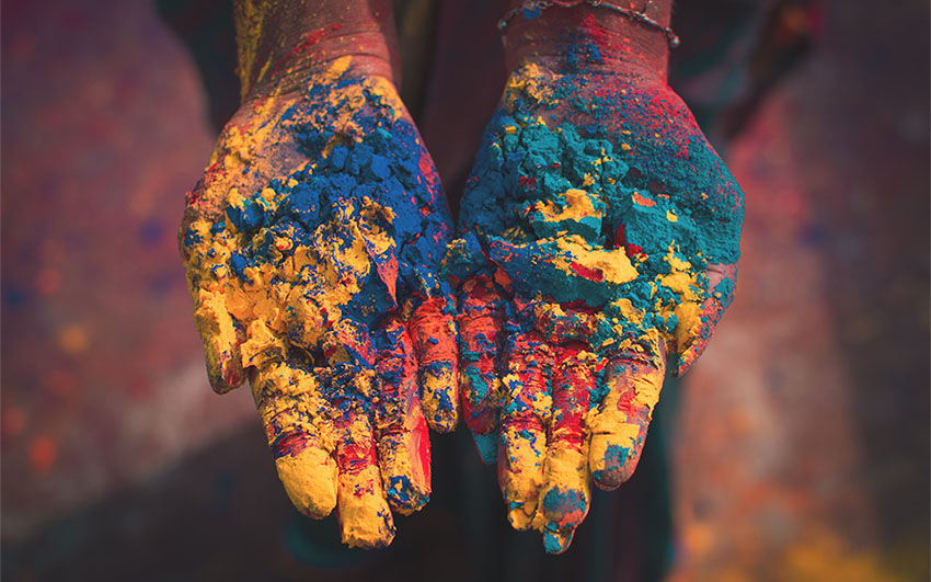Hands filled with Holi colours