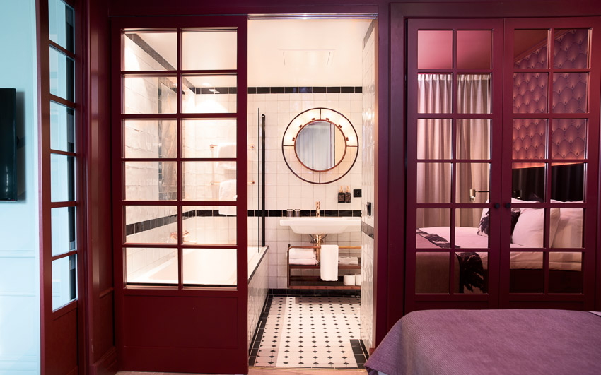 Semi-Open Bathroom Design with Glass-Paned Window for Doors, Black & White Tiled Floor, Golden Features - Beautiful Homes
