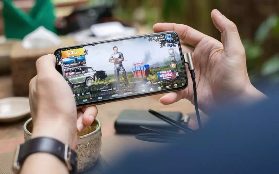 Man playing mobile games on his smartphone