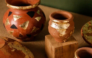 Terracotta pots decorated with golden paint