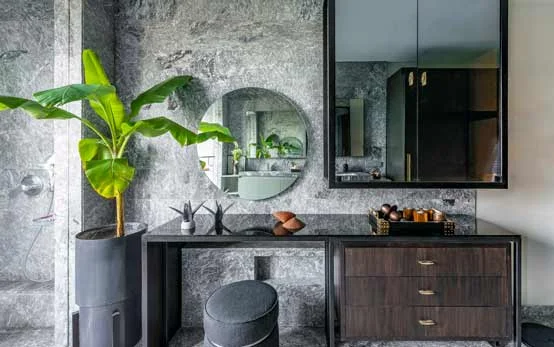 Dressing table with mirror in black modern design against granite wall with banana plant