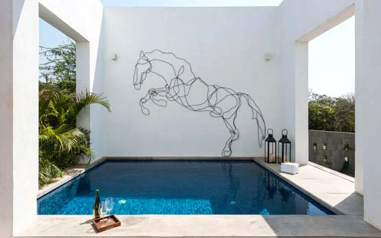 One-line installation on the clean white wall of a swimming pool design