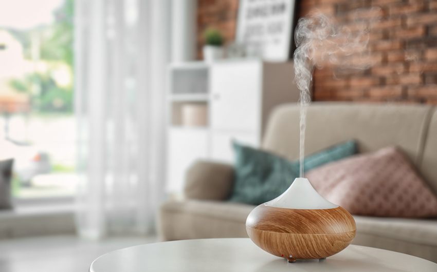 A living room with a fragrance diffuser with mist evaporating from it