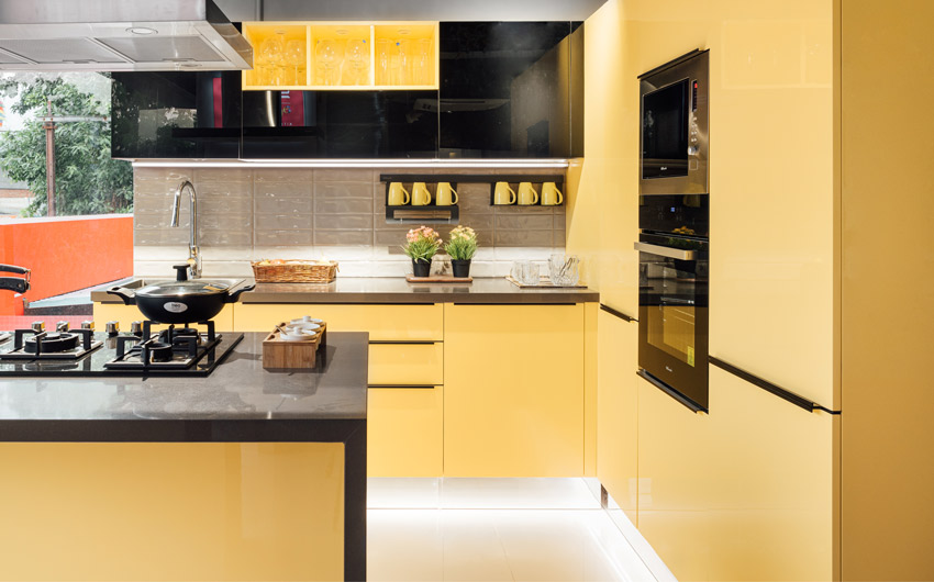 A kitchen with yellow cabinets and an island kitchen