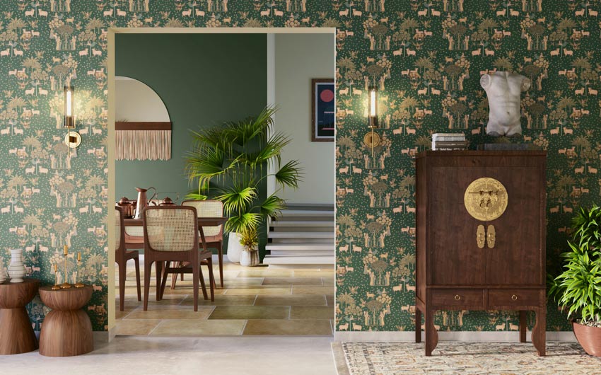 A green wallpapered room leading to a dining room