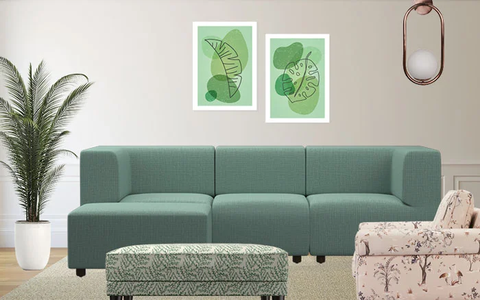 Living room with a green sofa, a floral sofa chair and a couple of art works