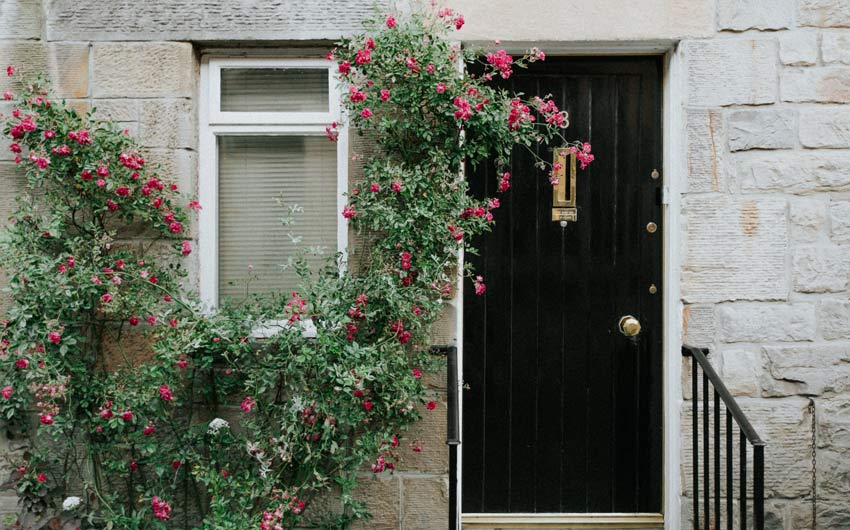 Beautiful black front door colour with rustic, cottage style exterior - Beautiful Homes