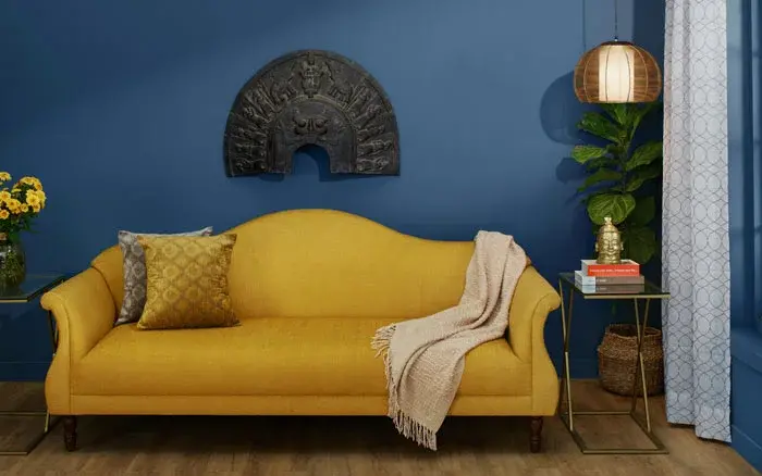 Blue room with a yellow sofa- Beautiful Homes
