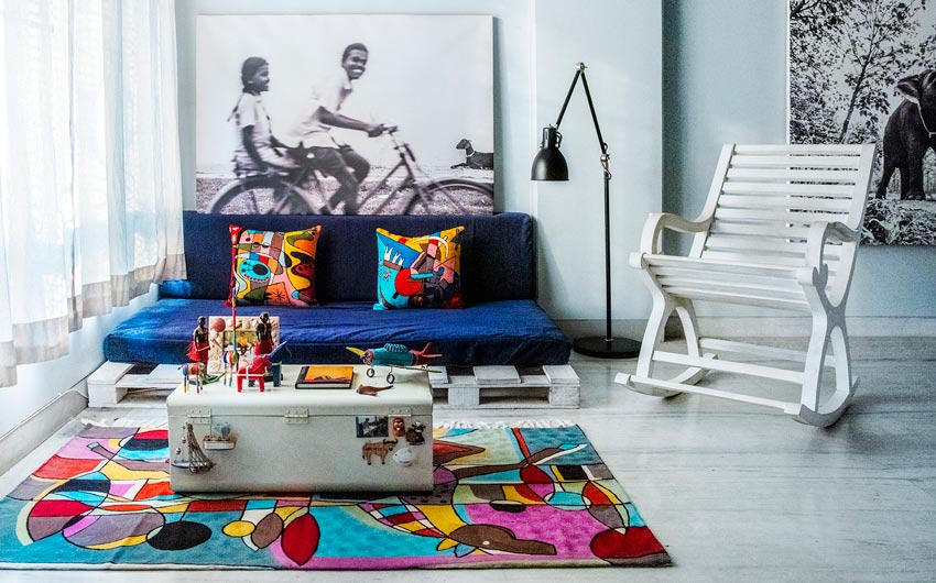 Print of children shot in Tamil Nadu hangs above the sofa design for living room design - Beautiful Homes