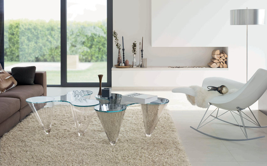 A unique glass top coffee table as an accent in the living room design - Beautiful Homes