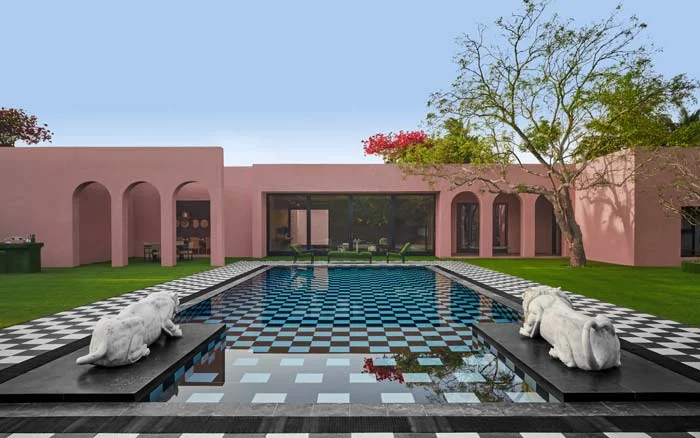 Pinakin Patel's red stone villa design with a big outdoor swimmimg pool - Beautiful Homes