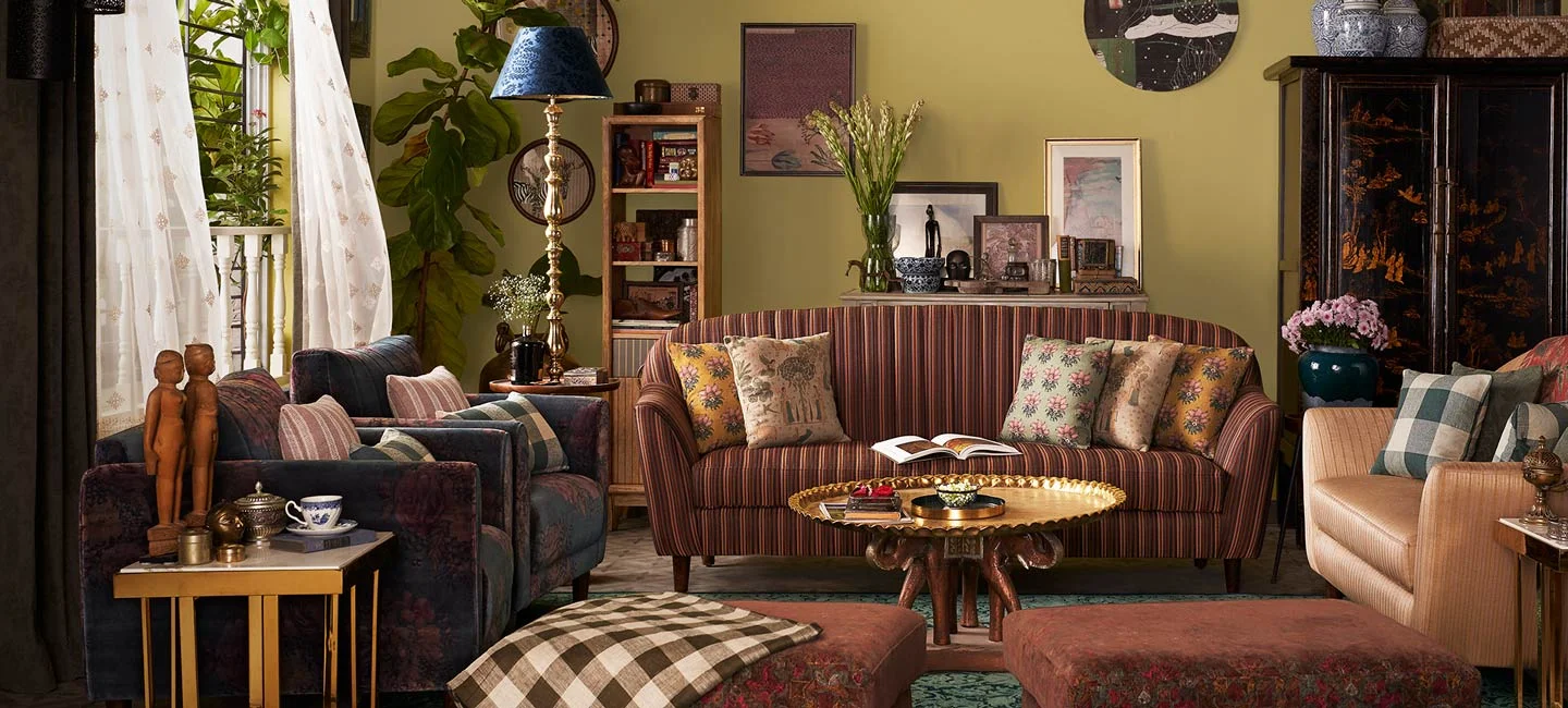 Yellow living room with a striped sofa chairs with floral fabric