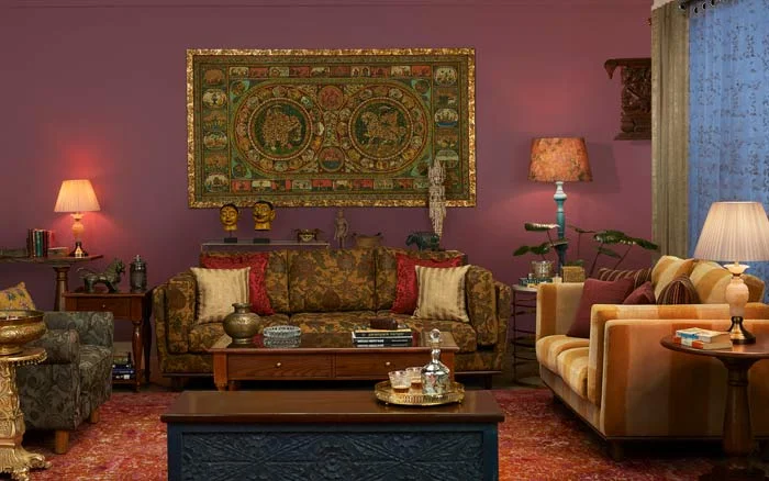 Maroon Living room with a floral sofa and artefacts