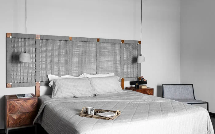 Grey interiors in Chennai with concrete pendant lights &amp; weave pattern headboard - Beautiful Homes