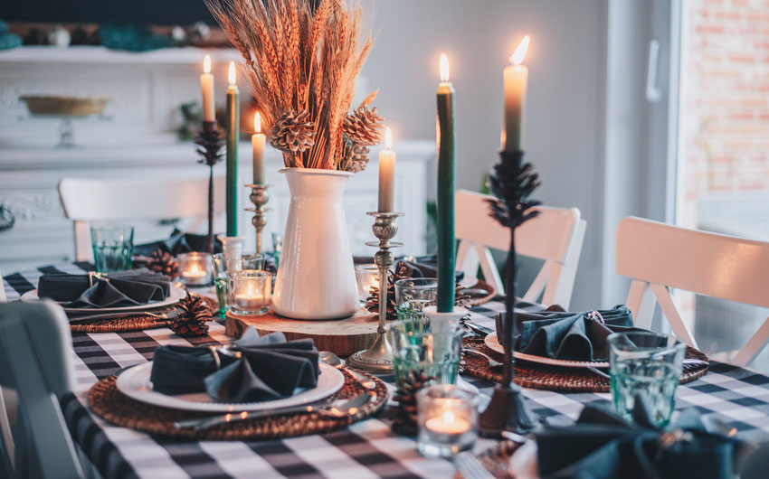 A christmas dinner table set up with candles etc