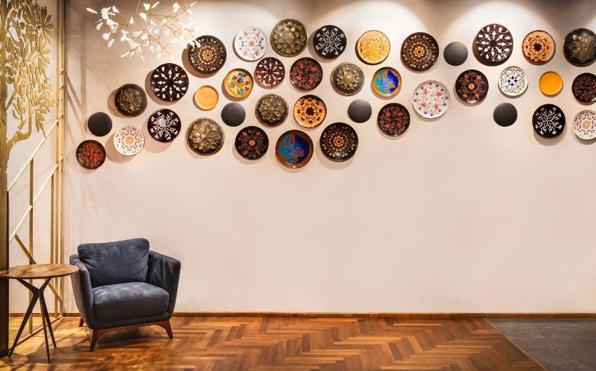 Wall decoration with circular patterned decor items & wall light - Beautiful Homes