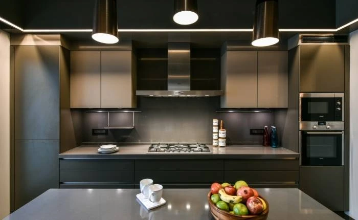 Metallic kitchen design trend with dark kitchen colour palette - Beautiful Homes