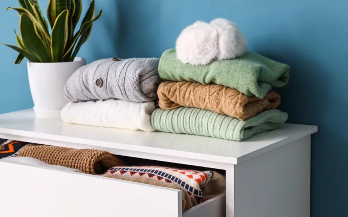 Woollen clothes on dresser