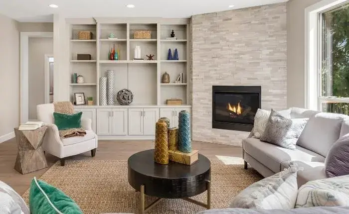 Stone fire place designs in a furnished living room - Beautiful Homes