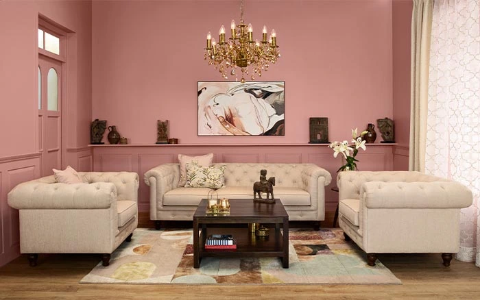 Modern living room with pink walls & chandelier - Beautiful Homes